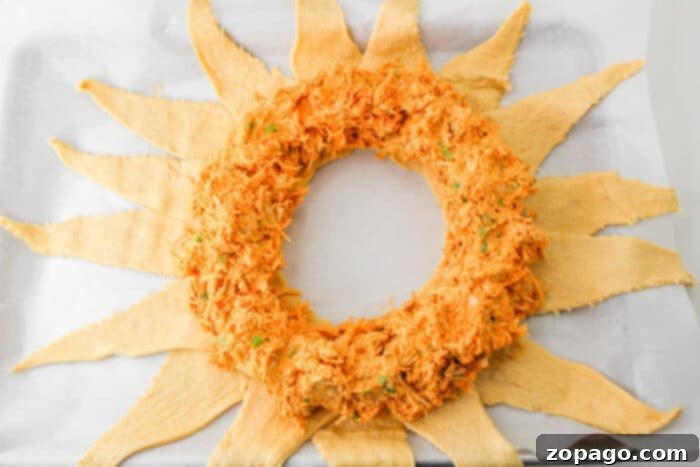 Chicken Crescent Roll Ring being assembled on a baking sheet