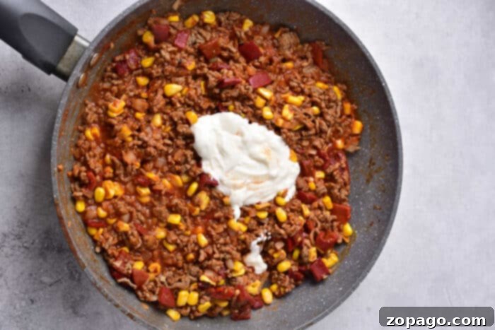 Hearty Taco Cornbread Bake 3 Close-up of a cheesy Taco Cornbread Casserole, showcasing its rich layers.