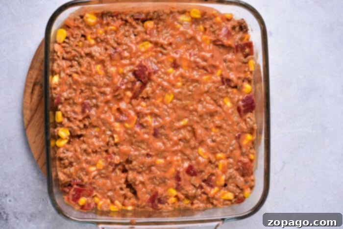 Hearty Taco Cornbread Bake 5 A dish showing the ground beef layer before the cornbread topping is added.