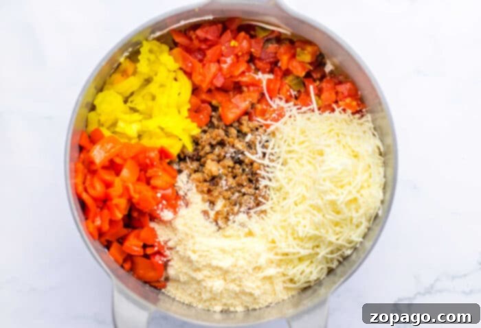 Spicy Rotel Sausage Dip 4 Ground Sausage Dip in a baking dish with vibrant ingredients