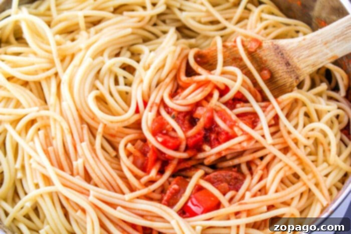 Hearty Sausage Spaghetti 8 spaghetti with sausage – a close-up of delicious pasta with sausage and sauce, garnished with fresh herbs.