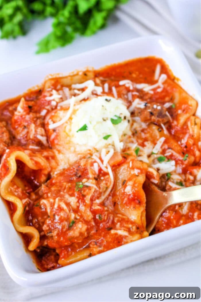Easy One Pot Lasagna Soup 2 Lazy Lasagna Soup simmering on the stove, garnished with fresh herbs