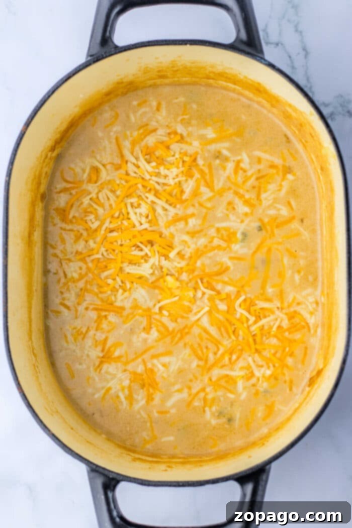 Hearty Beef and Spud Stew 4 Close-up of creamy, melted cheese in a rich steak soup, inviting a comforting culinary experience