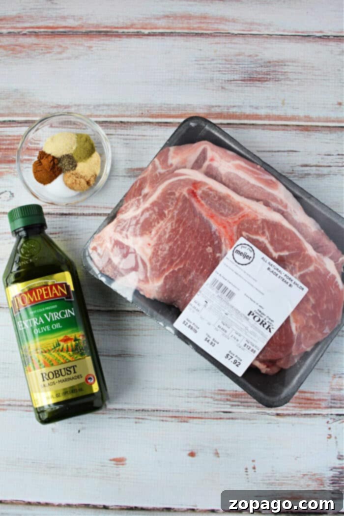 Tender Oven Baked Pork Steaks 4 Packaged pork steaks, perfect for transforming into succulent pork steaks in the oven, sit alongside a bowl of mixed spices and a bottle of olive oil on a light wooden surface.