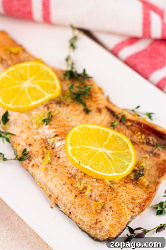 Oven-Baked Trout Perfection 2 Perfectly baked trout fillet with lemon slices, a healthy and easy dinner recipe.