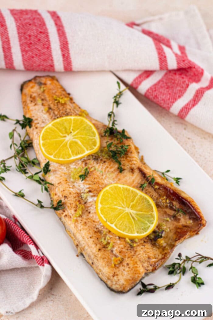 Oven-Baked Trout Perfection 7 Two plates of perfectly baked trout with lemon wedges and fresh dill, a complete healthy meal.