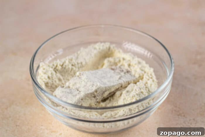 Crispy Fish Feast 4 Raw fish fillets lightly coated in flour and spices, prepared for frying