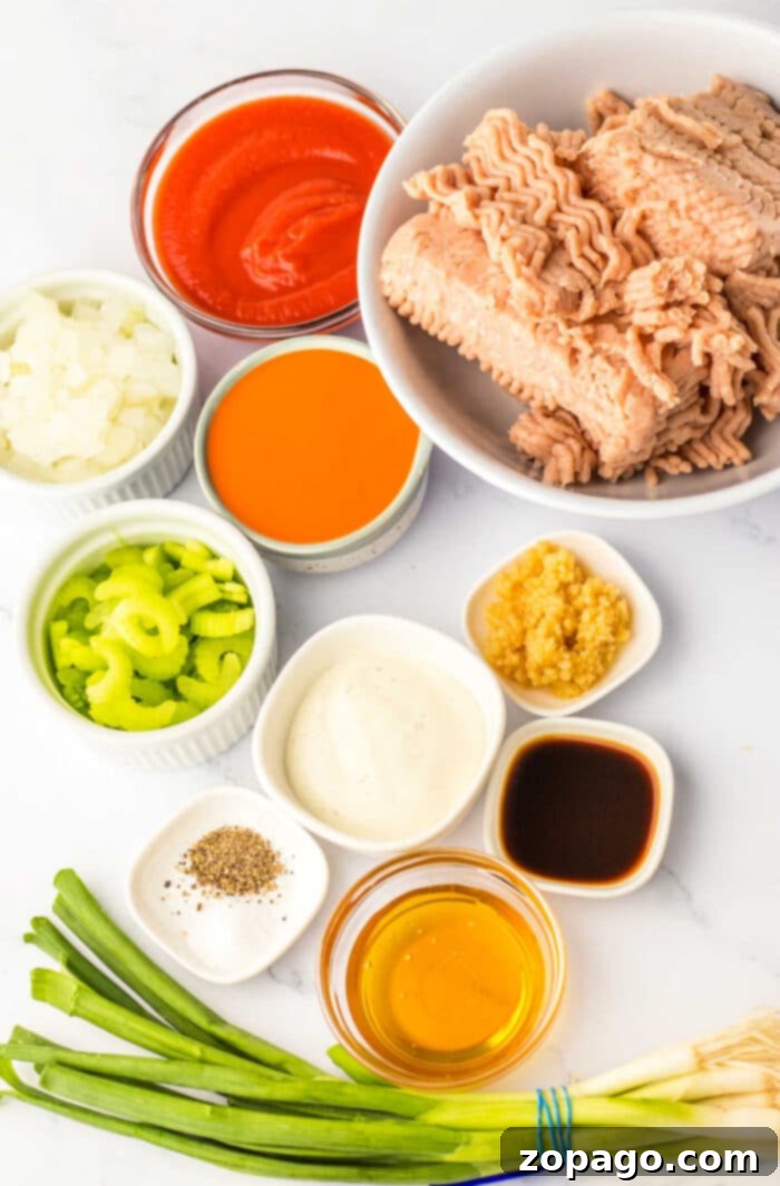 Hearty Chicken Sloppy Sandwiches 3 A vibrant close-up of a ground chicken sloppy joe sandwich, showcasing the rich, spicy buffalo sauce and fresh ingredients.