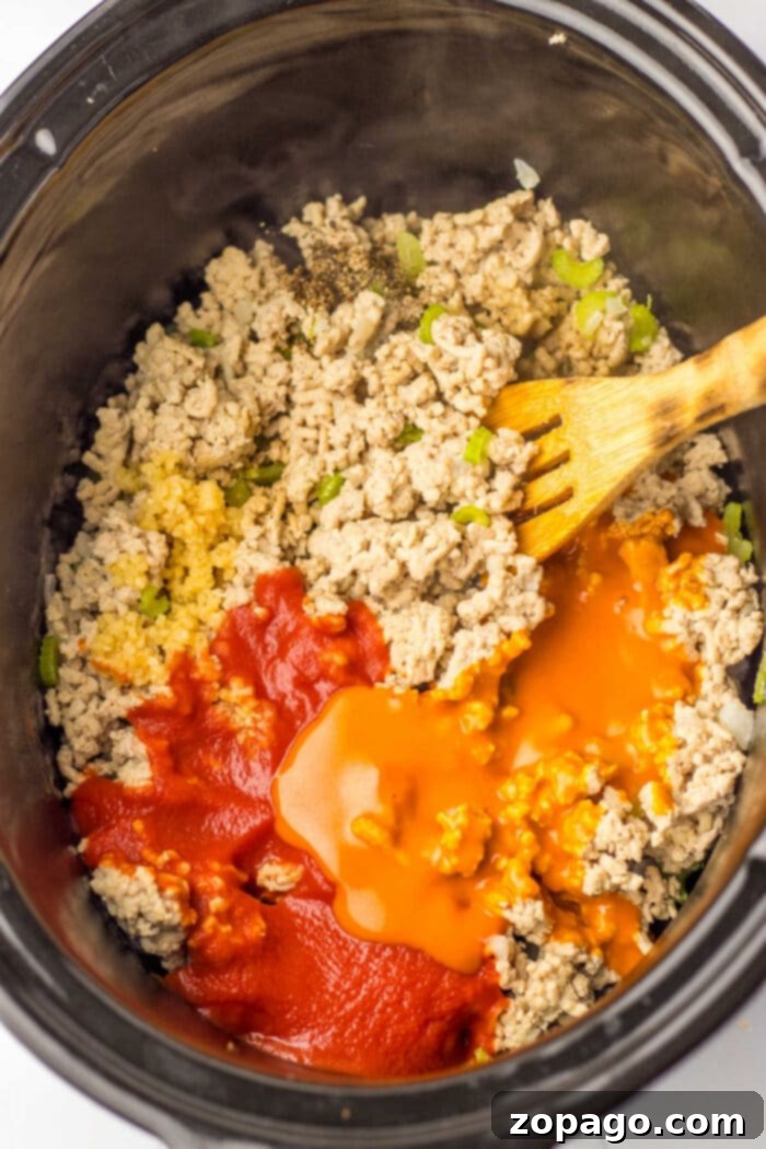 Hearty Chicken Sloppy Sandwiches 4 Loose meat sloppy joe mix with ground chicken and spicy buffalo sauce in a skillet, ready to be served on buns.