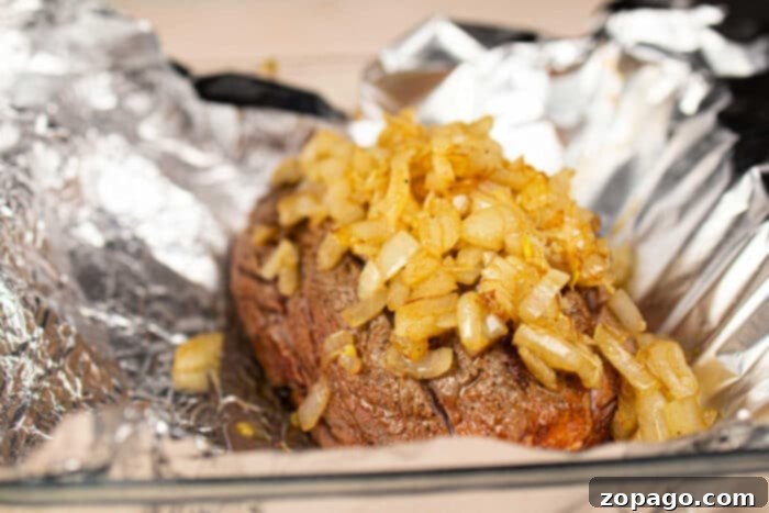 Chuck Roll Steak
A Cut Above: The Chuck Roll Steak Experience 4 Juicy chuck roll steak cooked to perfection, topped with sautéed onions, and resting on foil in a glass baking dish.