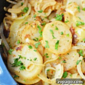 Home Fries 6 Fried potatoes and onions cooked to perfection in a skillet, garnished with fresh parsley