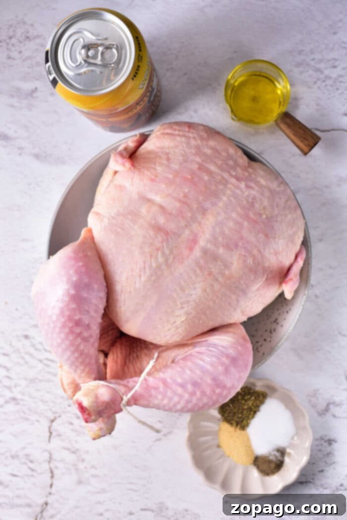 Oven-Baked Beer Can Chicken 3 Beautifully roasted oven beer can chicken, golden and crispy, resting in a glass baking dish.