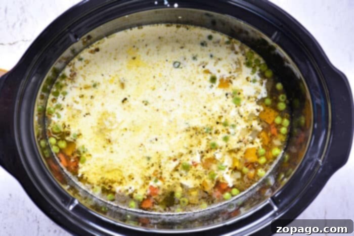 Slow Cooker Creamy Ground Beef and Potato Soup 6 Serving of creamy hamburger soup in a bowl, garnished and ready to eat.