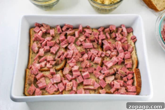 Hearty Corned Beef Bake 4 Casserole recipe featuring tender corned beef brisket and melted Swiss cheese.