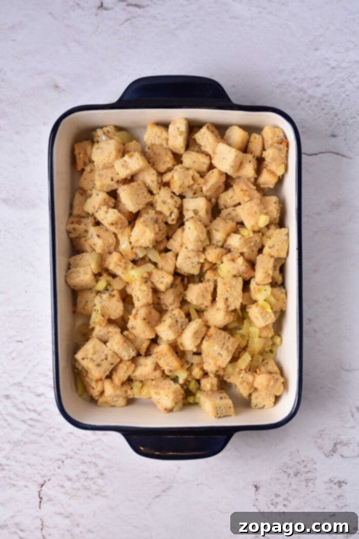 Crispy Sourdough Croutons 6 A rustic wooden bowl filled with golden-brown gluten-free croutons, lightly browned and seasoned, set against a dark, textured background.