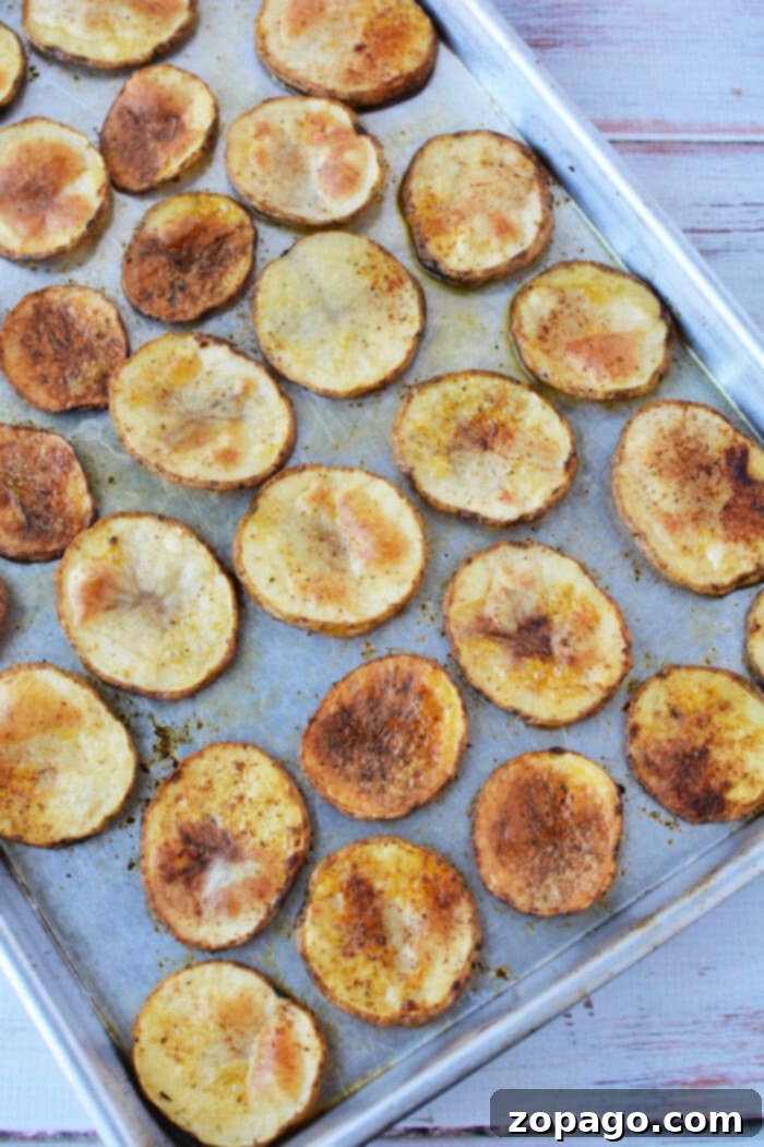 Crispy Oven Roasted Potato Slices 7 Batch of freshly baked potato slices in oven, ready to serve
