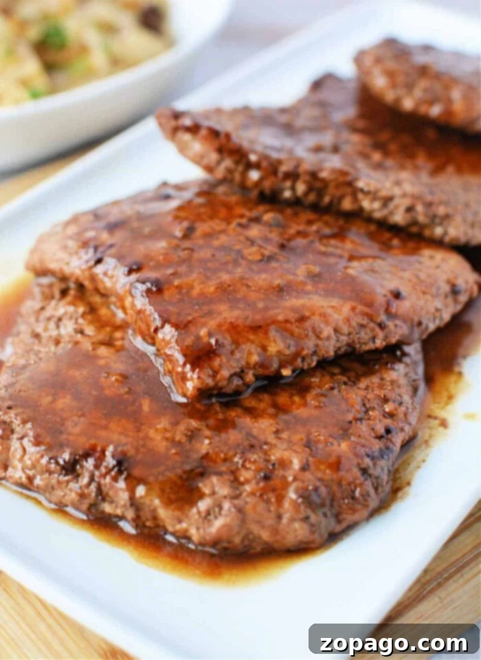 Frying Pan Cube Steak: Master the Cook Time 2 Juicy slices of perfectly cooked cube steak with a rich pan sauce, inviting diners to savor its tenderness – a testament to ideal frying pan cooking times.