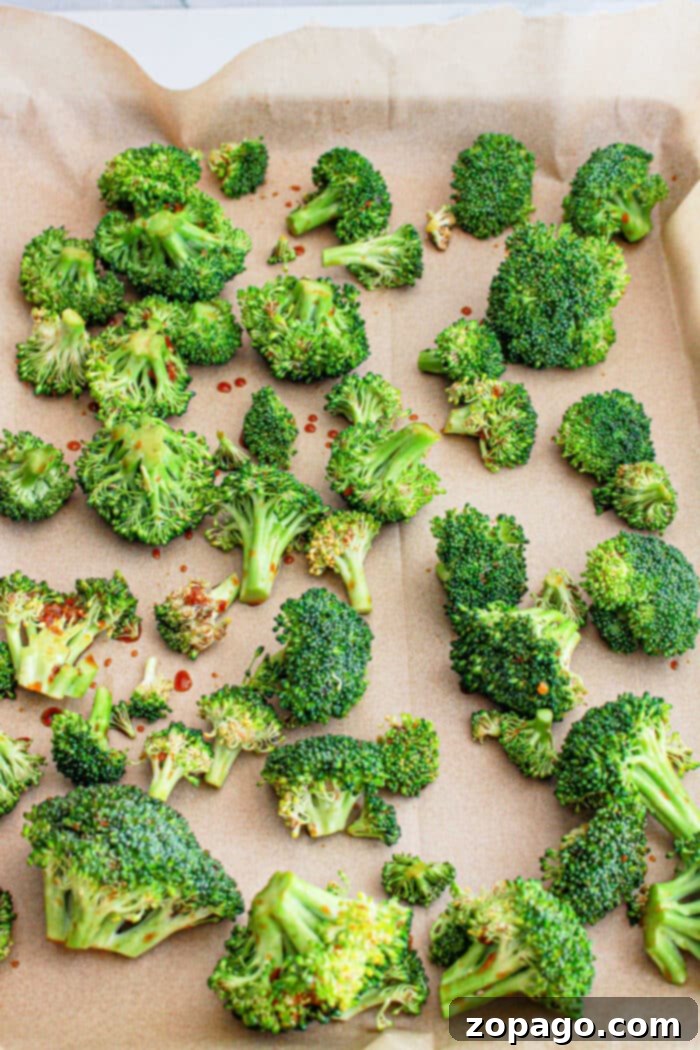 Chinese Broccoli 5 A sheet pan filled with golden-brown roasted Asian broccoli, ready to be served.