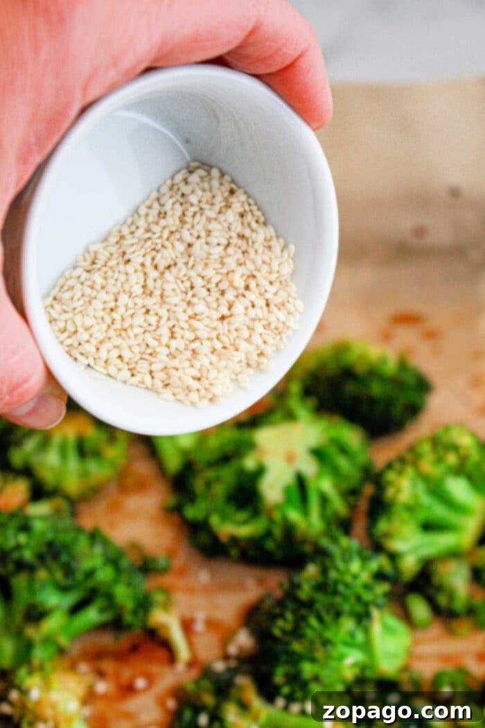 Vibrant Gai Lan Stir Fry 5 Close-up of a spicy roasted broccoli recipe served in a elegant white bowl, garnished with sesame seeds and vibrant green onions.