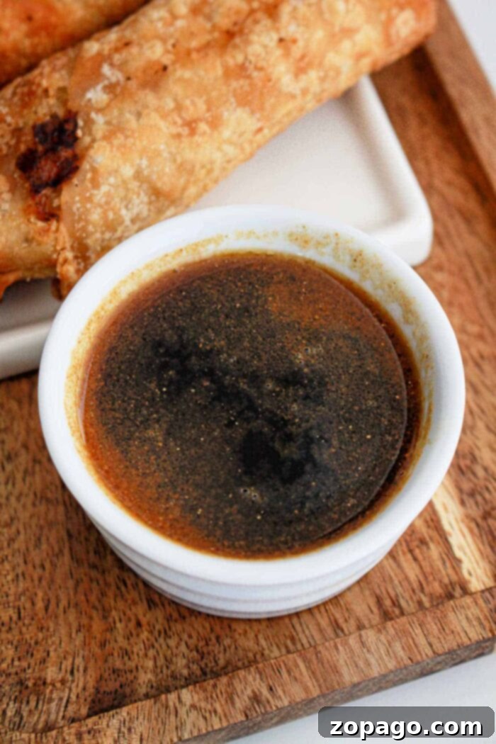 Signature Egg Roll Dipping Sauce 6 A bowl of savory soy-based egg roll sauce