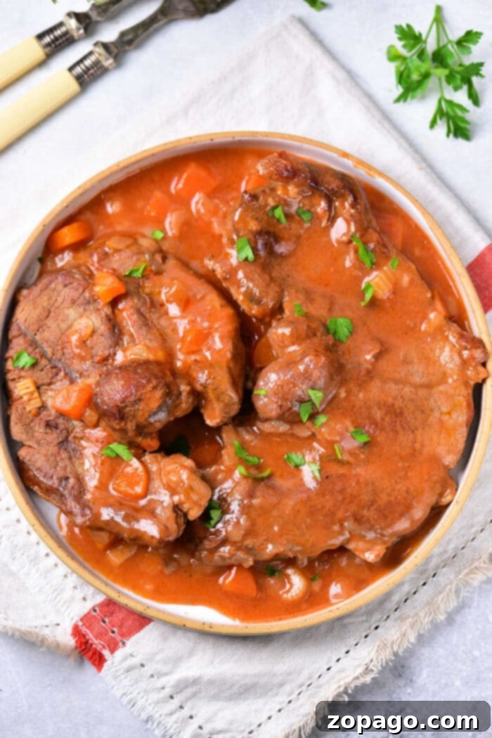 Fall-Apart Tender Beef Shin 2 Tender oven-braised beef shin in a rich tomato sauce, served in a Dutch oven.