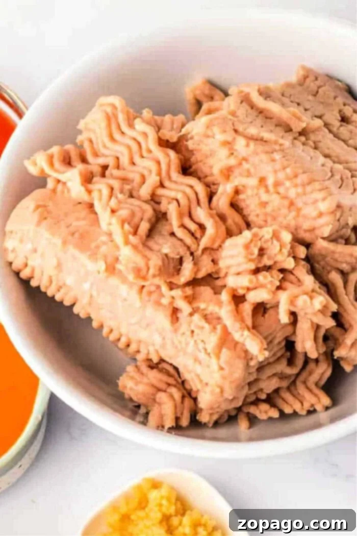 Perfectly Cooked Ground Chicken: A Timing Guide 2 A bowl of raw ground chicken with a patterned texture awaits its transformation, similar to considerations on how long to cook ground chicken.