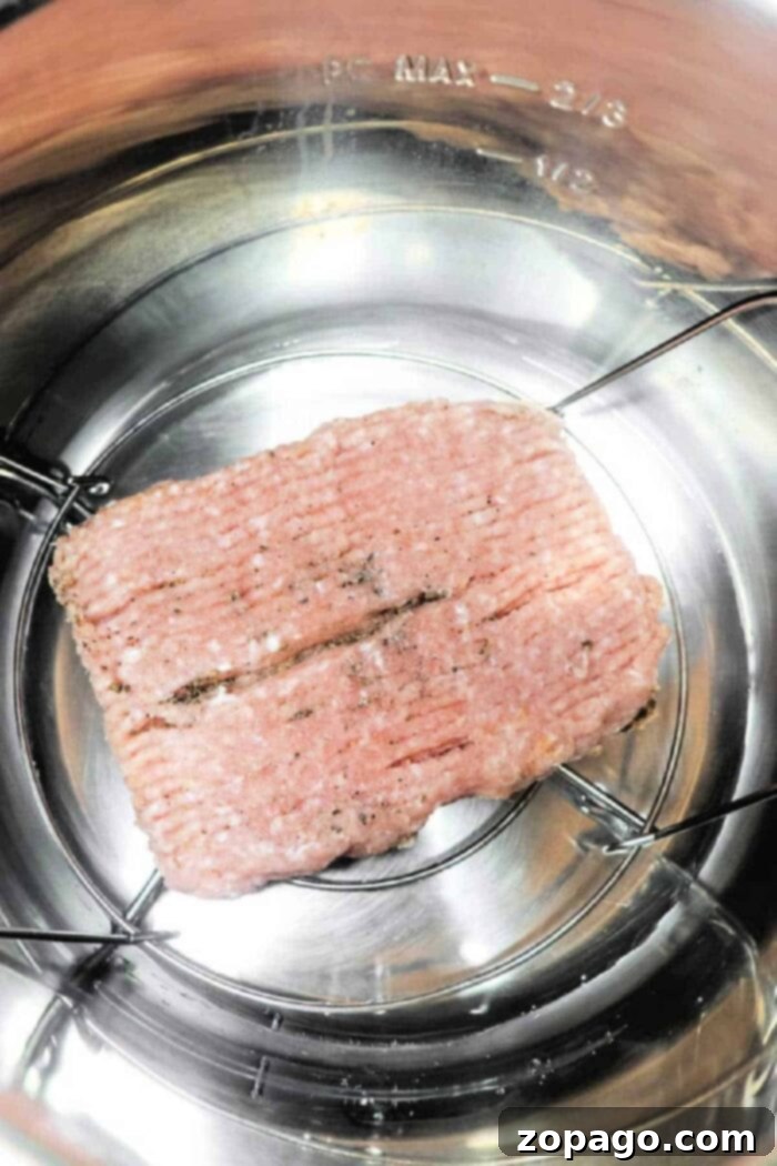 Perfectly Cooked Ground Chicken: A Timing Guide 3 Ground chicken on a metal trivet inside an Instant Pot, ready for cooking. Wondering how long to cook ground chicken? You’ll find it cooks quickly and evenly, making meal prep a breeze.