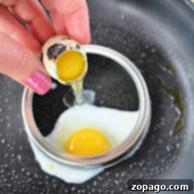 Discover how to cook quail eggs perfectly by cracking them into a cooking ring on a frying pan. With one egg already nestled inside the ring, youre set to create a delightful treat with ease and precision.