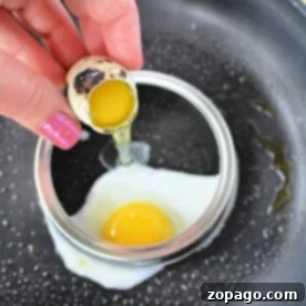Discover how to cook quail eggs perfectly by cracking them into a cooking ring on a frying pan. With one egg already nestled inside the ring, you're set to create a delightful treat with ease and precision.