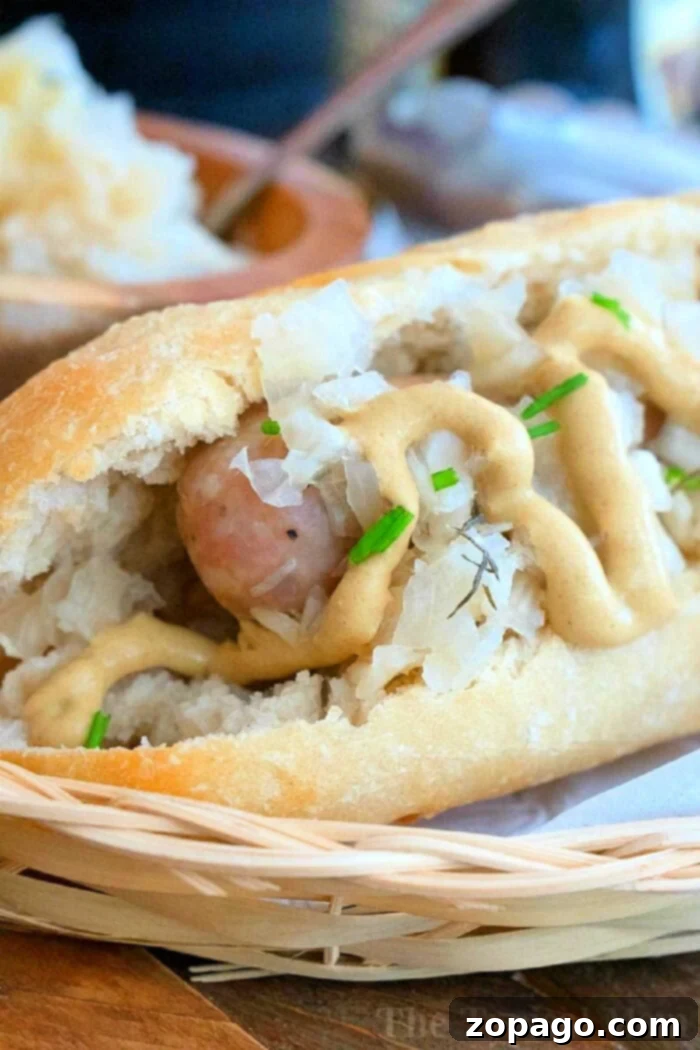 The Perfect Boil Time for Brats 2 Perfectly Boiled Brats served in a bun with mustard and sauerkraut, ready to eat.