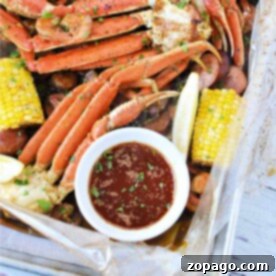 Ultimate Seafood Boil Sauce 6 Savor the ultimate seafood boil featuring crab legs, corn, and sausages, all enhanced by a zesty lemon wedge. Accompanied by a mouthwatering dipping sauce crafted from our special seafood boil sauce recipe, this feast is a true delight for the senses.