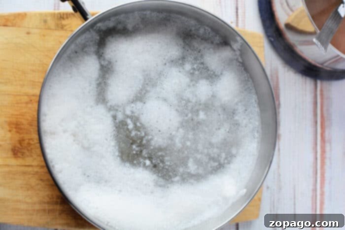 Chicken Tender Boiling Times 5 A pot of boiling water on a stove, ready for cooking chicken. This image highlights the initial step of how to boil chicken tenders effectively.