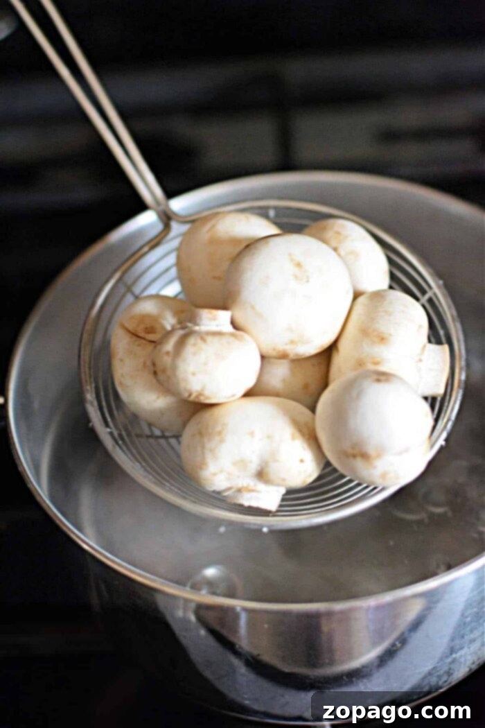 Simmered Mushrooms 5 Close-up of mushrooms boiling on the stove, perfect for a side dish or gravy.