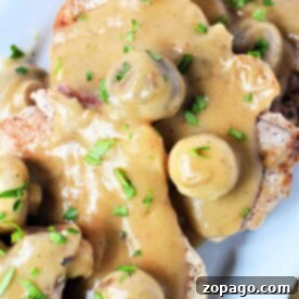 Savor the flavors of pork chops with mushroom gravy, garnished with fresh parsley for a delightful finish.