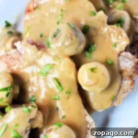 Savor the flavors of pork chops with mushroom gravy, garnished with fresh parsley for a delightful finish.