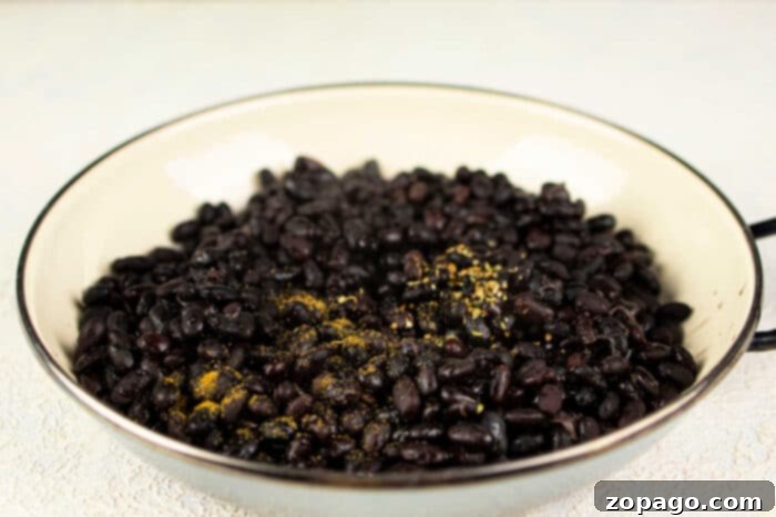 Pantry Staple Refried Black Beans 5 black beans refried in a pan