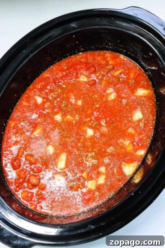 Crafting Flavorful Chili with Dried Beans 7 A slow cooker filled with rich, simmering chili with dried beans, ready for a comforting meal.