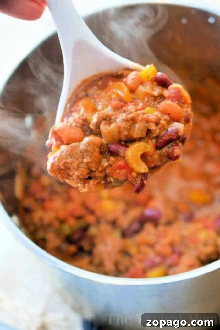 Crafting Flavorful Chili with Dried Beans 8 A large pot of rich, homemade chili with dried beans, garnished with fresh toppings, ready to be served.