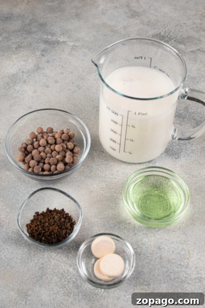 Perfect Homemade Boba for Bubble Tea 3 Ingredients for making boba, including milk, chocolate chips, instant coffee, mint oil, and tapioca pearls on a table
