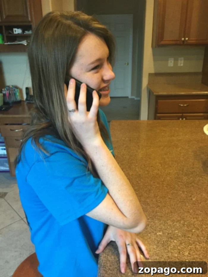 Choosing the Perfect First Phone for Your Tween 5 Happy girl with her Walmart Family Mobile phone
