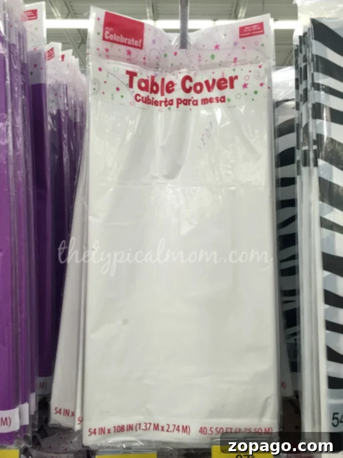 Cheap Indoor Games: Easy DIY Giant Checkers Setup for Family Fun Two hands arranging colorful napkins on a white tablecloth, setting up a cheap indoor game for kids – a DIY giant checkerboard.