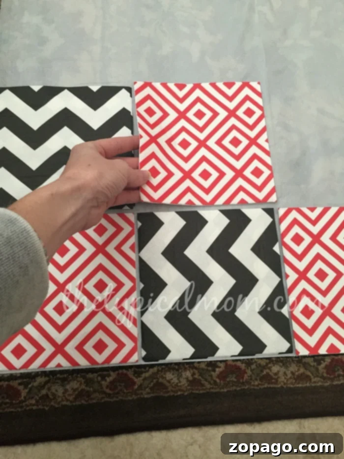 DIY Checker Board Game: Arranging Napkins for Creative Family Fun Close-up of different patterned napkins being arranged on a white tablecloth, forming the squares of a do-it-yourself checker board game.