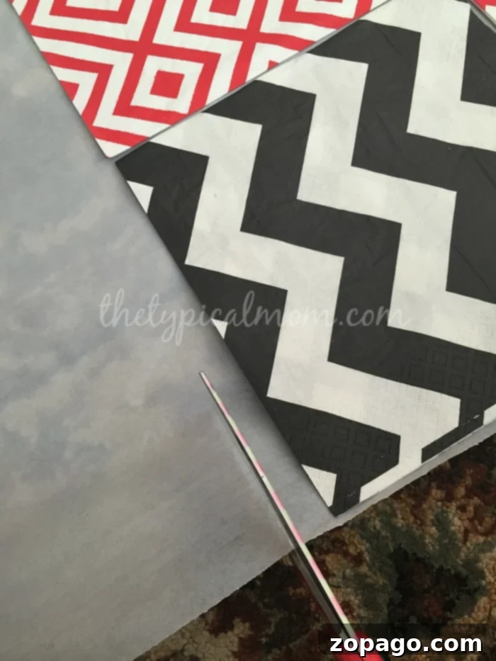 Simple DIY Checker Board: Assembling Your Giant Game Board with Napkins The partially completed DIY checker board, showing an 8x8 grid of alternating patterned napkins laid out on a white tablecloth. A simple yet effective setup for a giant checker game.