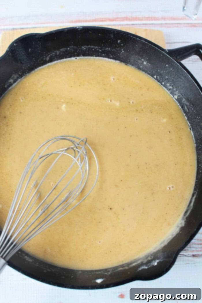 A bowl of the easiest and most delicious homemade mushroom gravy, ready to be served over any favorite dish.