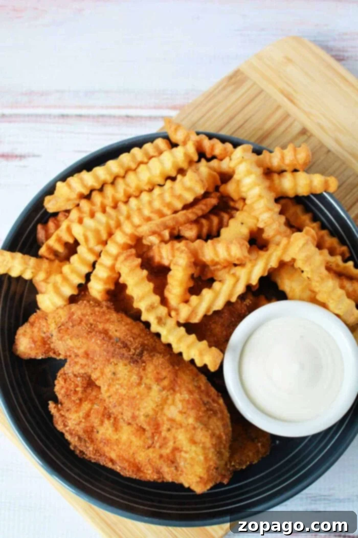 Crispy Homemade Chicken Tenders 7 Copycat Raising Cane's Tenders - Close-up of perfectly pan-fried chicken tenders, resembling a popular restaurant style.
