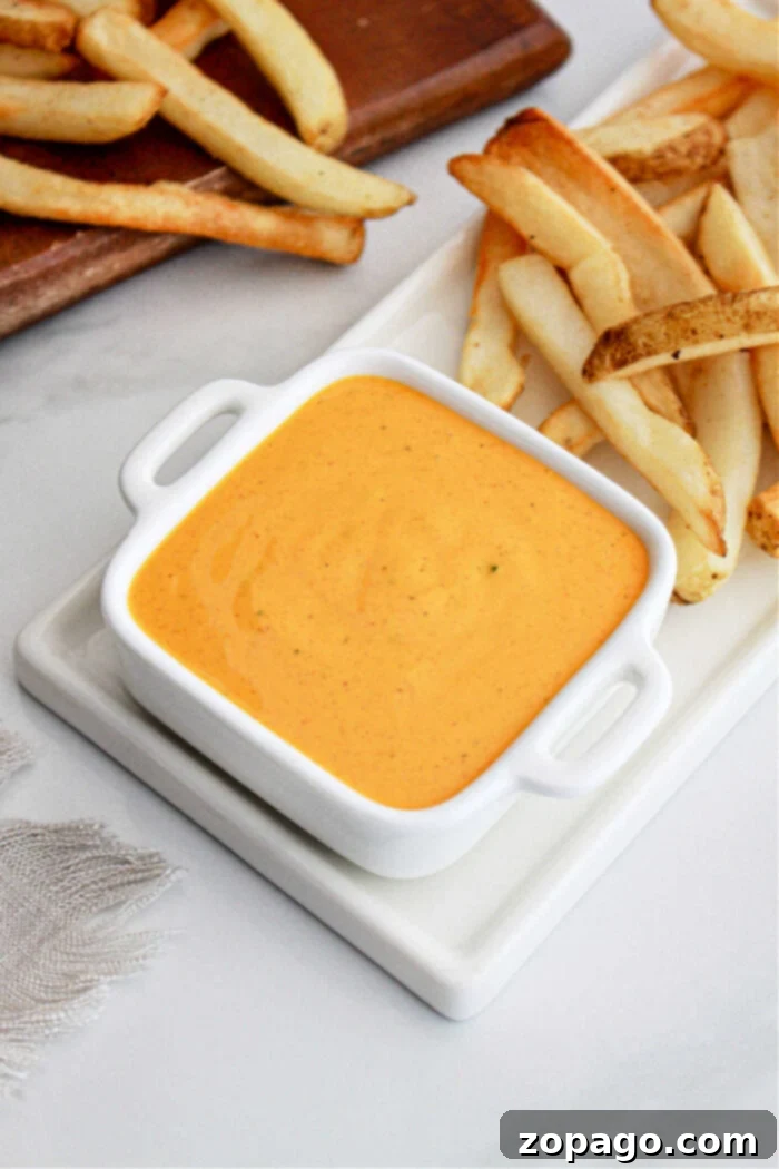 The Ultimate KFC Buffalo Ranch 6 Overhead view of a bowl of homemade Buffalo Ranch sauce with a rustic background