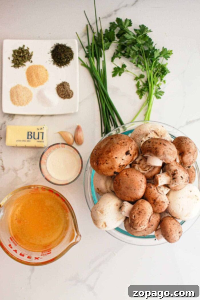 Simple Savory Crockpot Mushrooms 3 Essential ingredients for crockpot mushrooms: fresh mushrooms, aromatic herbs, butter, minced garlic, a touch of cream, and vegetable broth, neatly arranged on a marble surface.