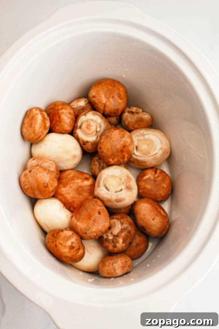 Simple Savory Crockpot Mushrooms 4 Delicious garlic butter mushrooms simmering gently in a slow cooker, ready to absorb all the rich flavors.