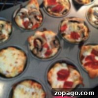 Savor the delightful aroma of pizza muffins as mini pizzas with assorted toppings like pepperoni and mushrooms bake to perfection in a muffin tin.