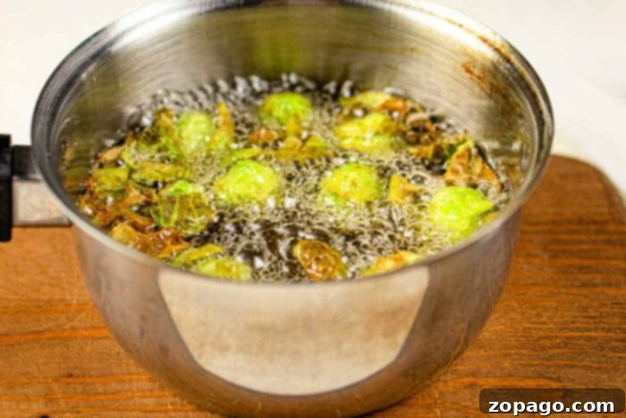 Golden Crispy Brussels Sprouts 3 Preparing brussels sprouts for frying by cutting them in half